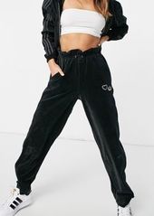adidas Originals Bellista velour cuffed sweatpants in black