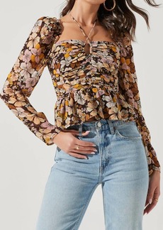 ASTR Toni Ruched Halter Long Sleeve Peplum Top In Brown Yellow Floral
