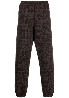 Moschino all-over embroidered logo track pants