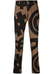 Moschino graphic-print pressed-crease trousers