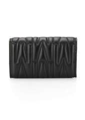Moschino monogram-quilted clutch bag