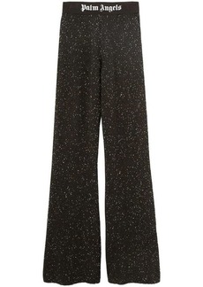 PALM ANGELS FLARED TROUSERS WITH PRINT