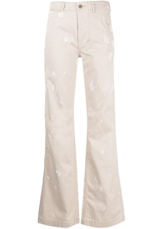 R13 paint-splatter flared trousers