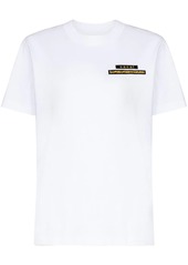 Sacai x Hank Willis Thomas slogan-print T-shirt