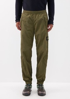 Stone Island - Logo-patch Metallic-shell Trousers - Mens - Olive
