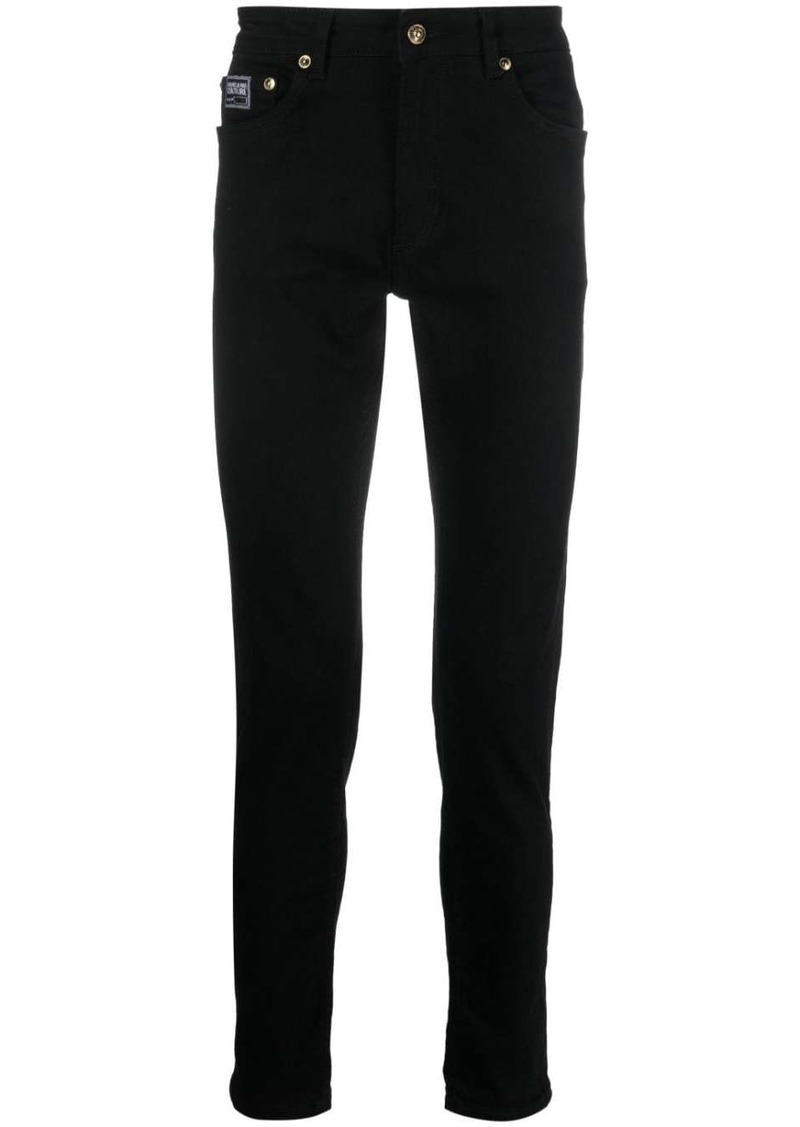 Versace logo-patch cotton trousers